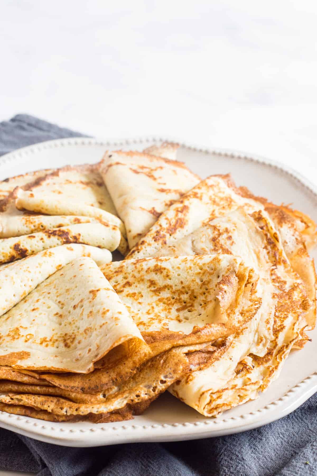 Folded crepes on a plate.