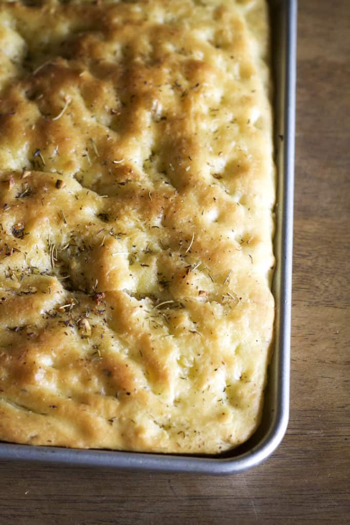 Garlic and Rosemary Focaccia - Focaccia made with olive oil infused rosemary, thyme and garlic. This bread will satisfy any craving for the Italian bread. | wanderzestblog.com #focaccia #rosemary #garlic #bread #recipe