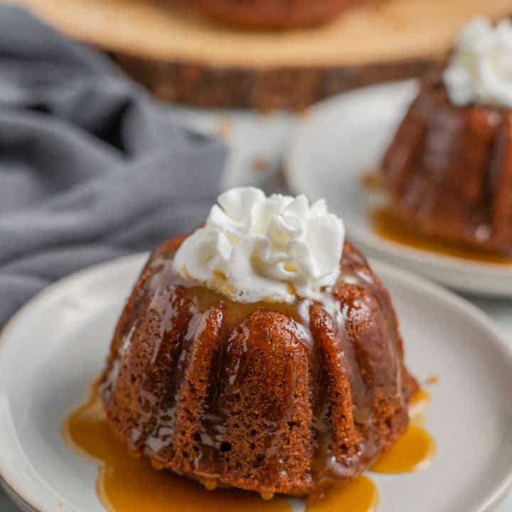 Sticky toffee pudding on a white plate.