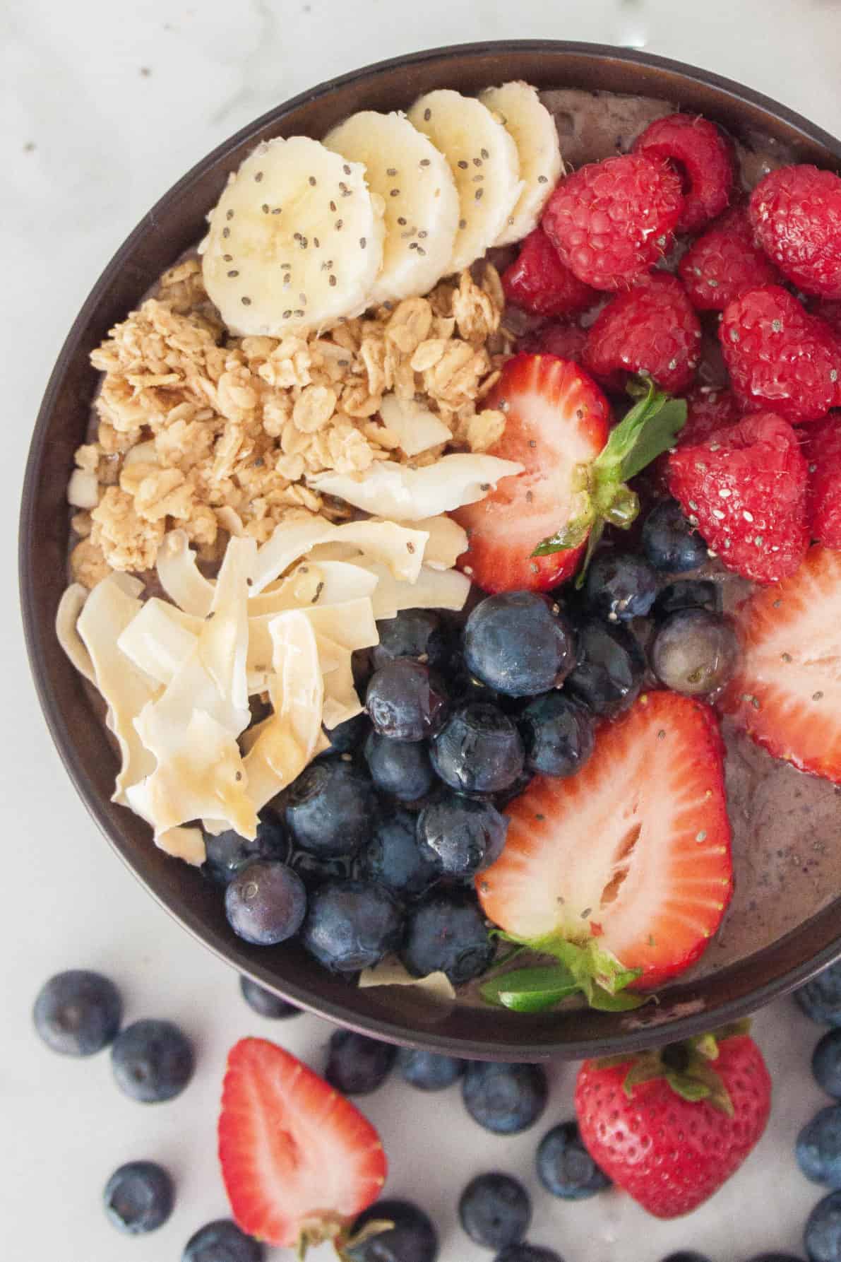 Homemade Hawaiian Acai Bowl topped with fresh berries and other tasty toppings.