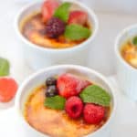 Creme Brulee in white ramekins on a marble surface.