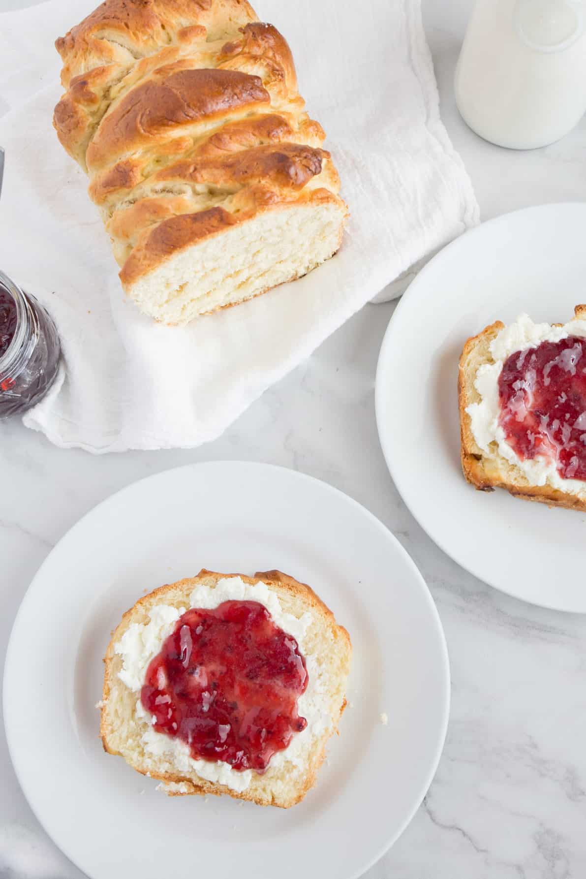 Slices of Brioche Bread topped with ricotta and jam.