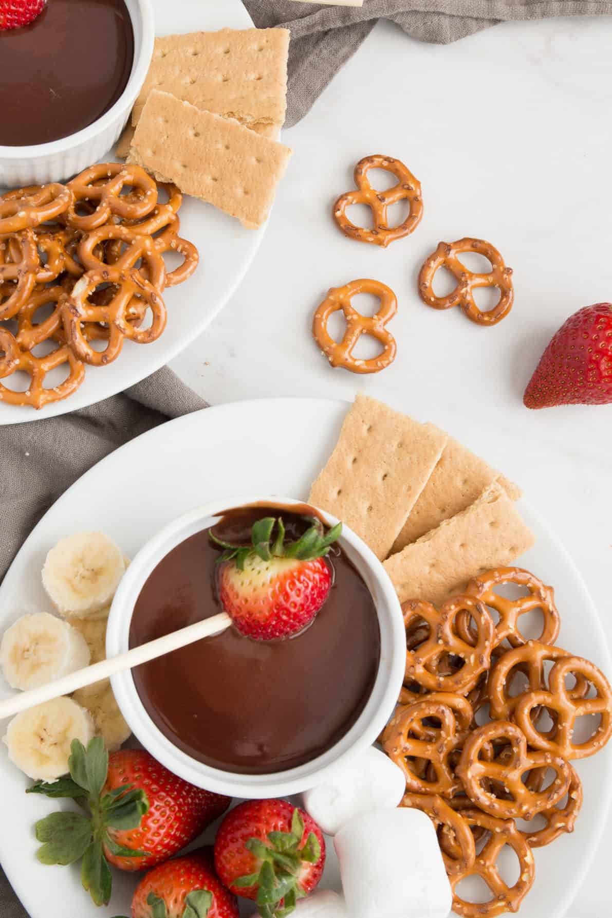 Chocolate Fondue is a fun and easy dessert experience! This no-fuss recipe is silky smooth and decadent, perfect for a variety of dipping options.This dessert is sure to be at hit at an party. | wanderzestblog.com #fondue #chocolate #party #dessert #holiday