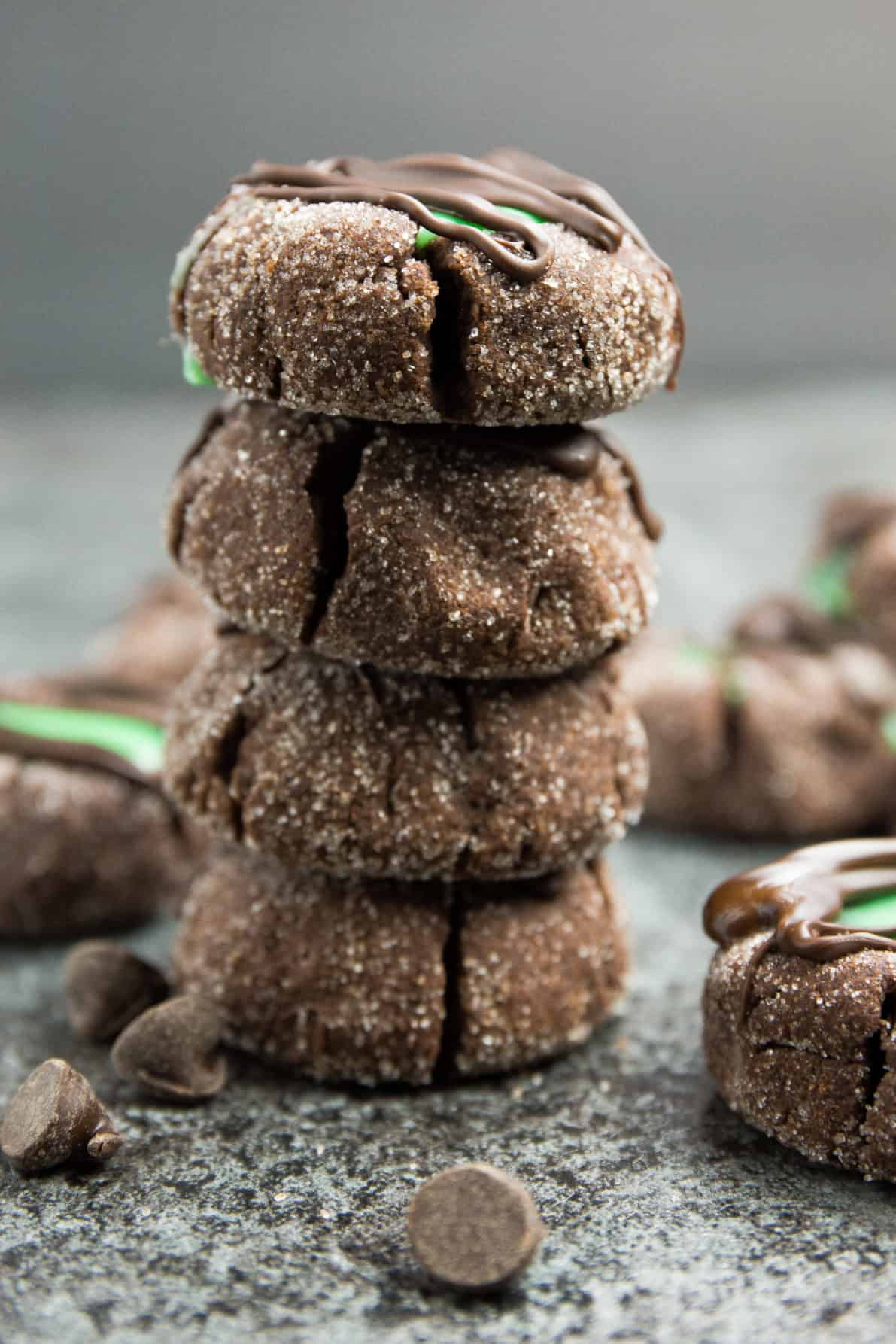 Mint chocolate thumbprint cookies stacked on each other.