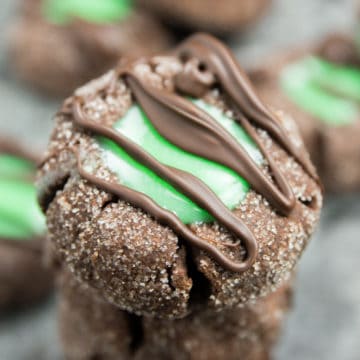 Mint Chocolate Thumbprint cookies stacked on each other.