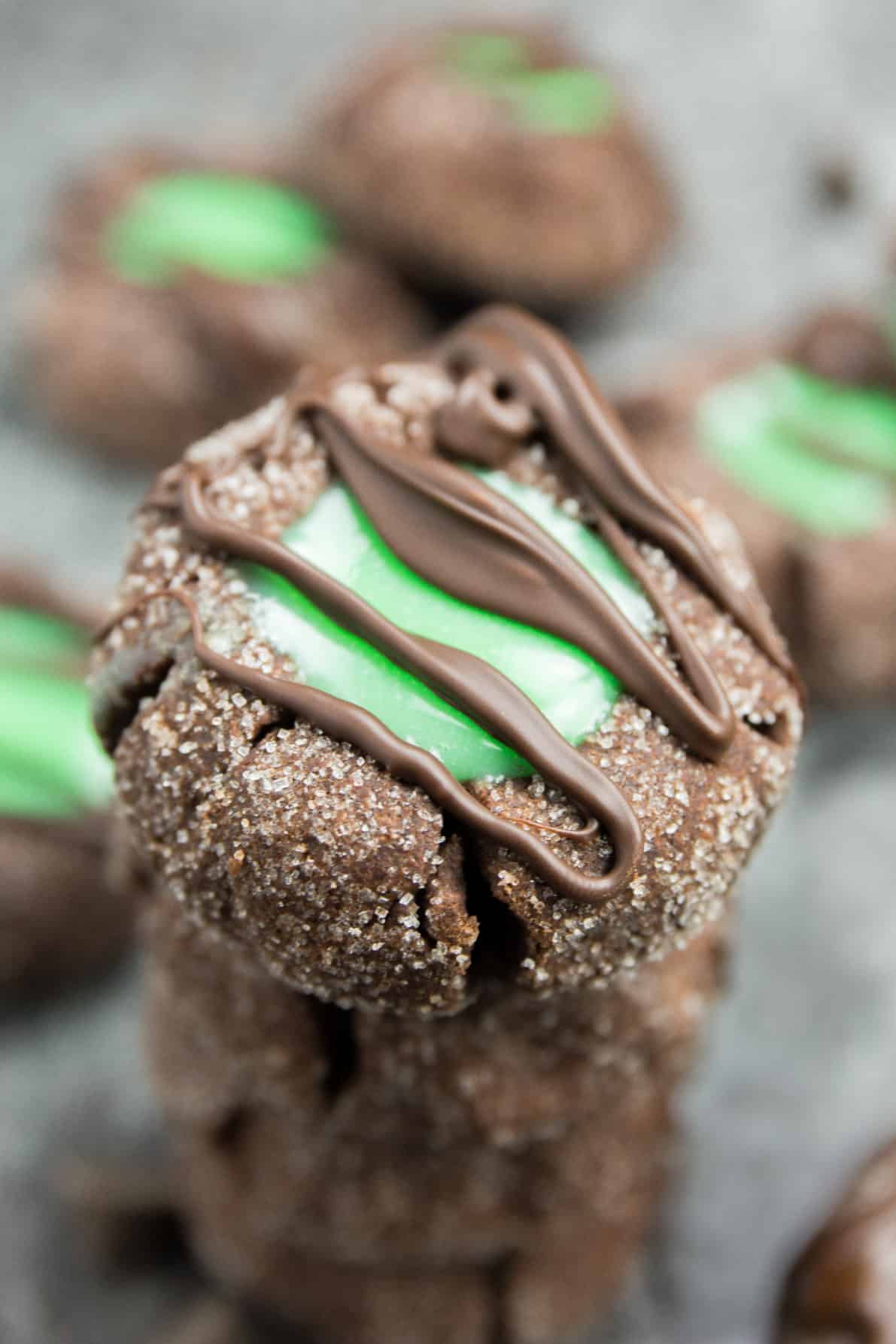 Mint Chocolate Thumbprint cookies stacked on each other.
