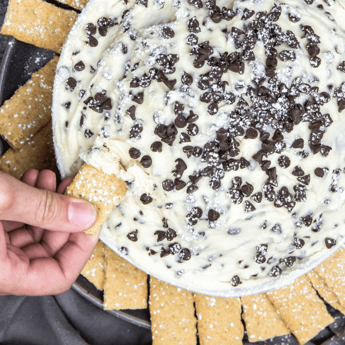 A bowl full of cannoli dip on a gray surface.