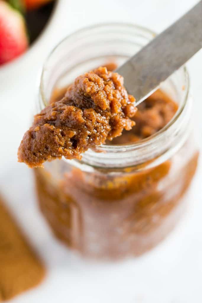 Jar of cookie butter with a butter knife.