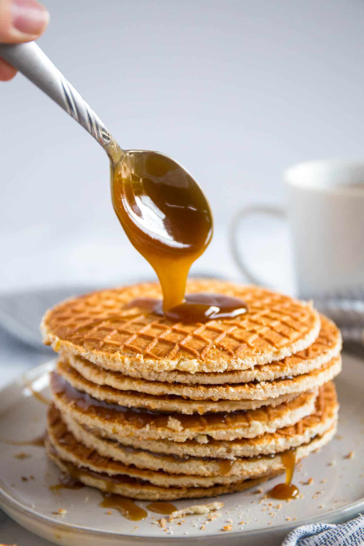 A stack of stroopwafels with caramel drizzled on top.