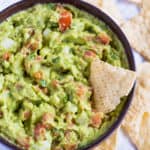 A bowl of authentic guacamole with chips.
