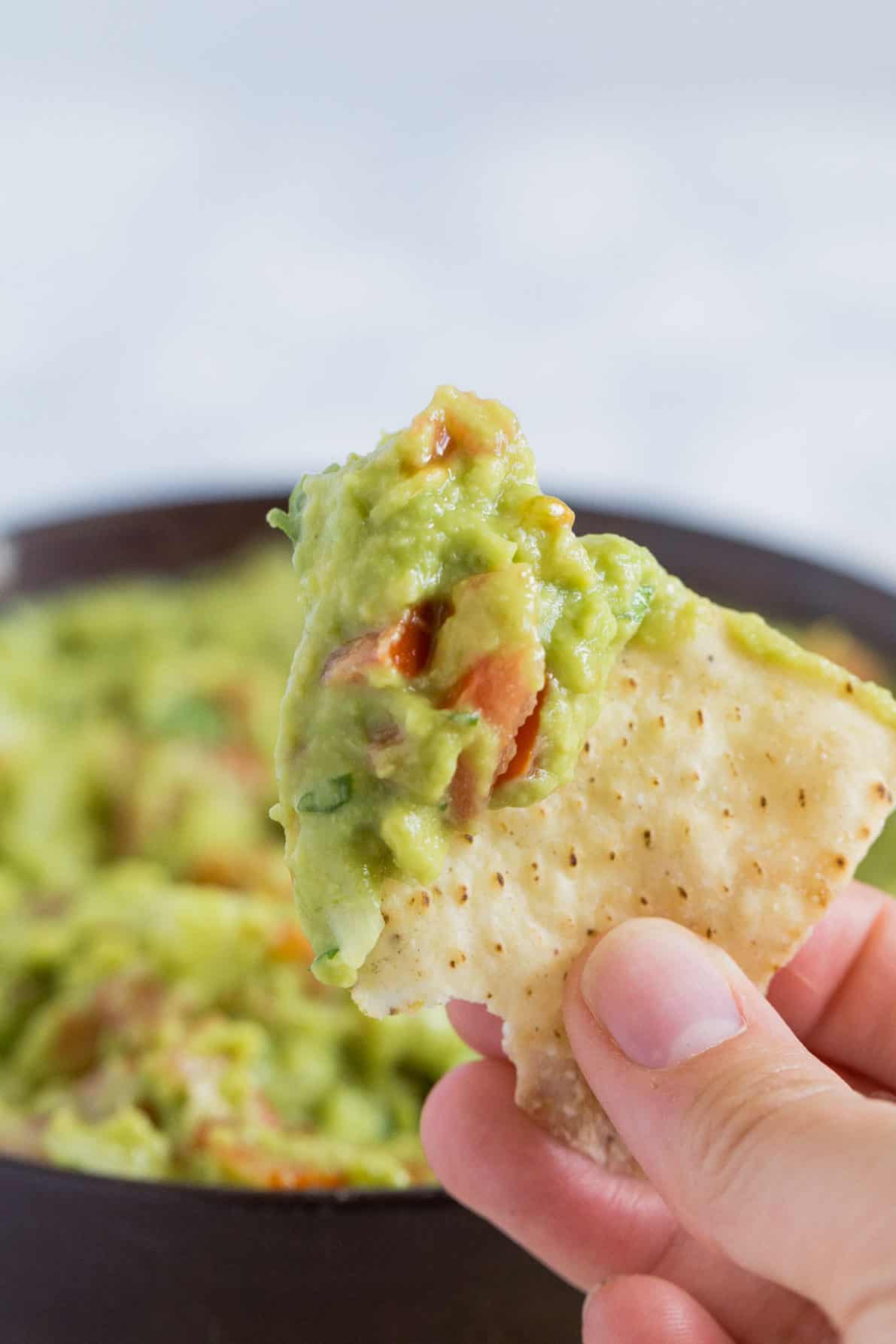 A chip dipped into authentic guacamole.