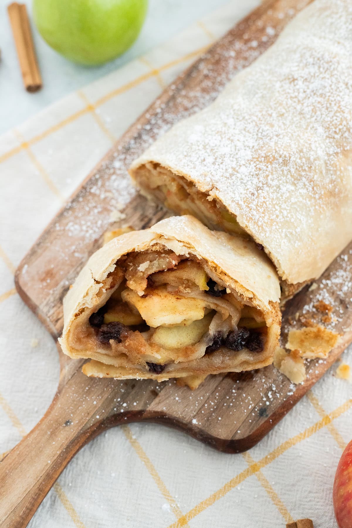 Apple Strudel with a slice taken out to show the apple filling.