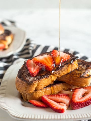 Creme Brulee French Toast on a plate with strawberries.