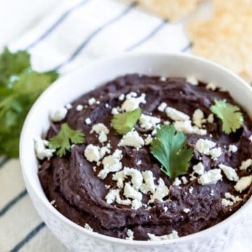 Instant Pot Refried Black Beans in a white bowl.