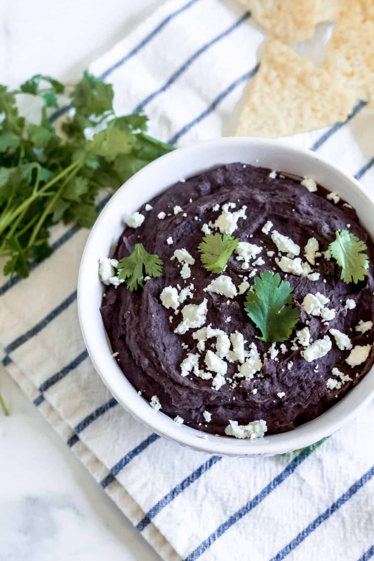 Instant Pot Refried Black Beans in a white bowl.