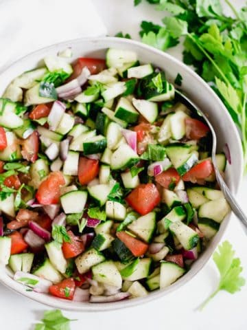 Egyptian Tomato and Cucumber Salad in a white bowl.