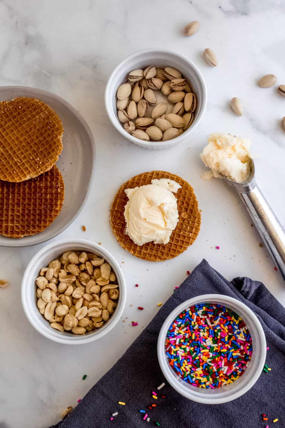 Stroopwafel ice cream sandwiches ingredients laid out on a marble surface.