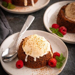 Mexican Hot Chocolate lava cake topped with vanilla ice cream on a white plate.