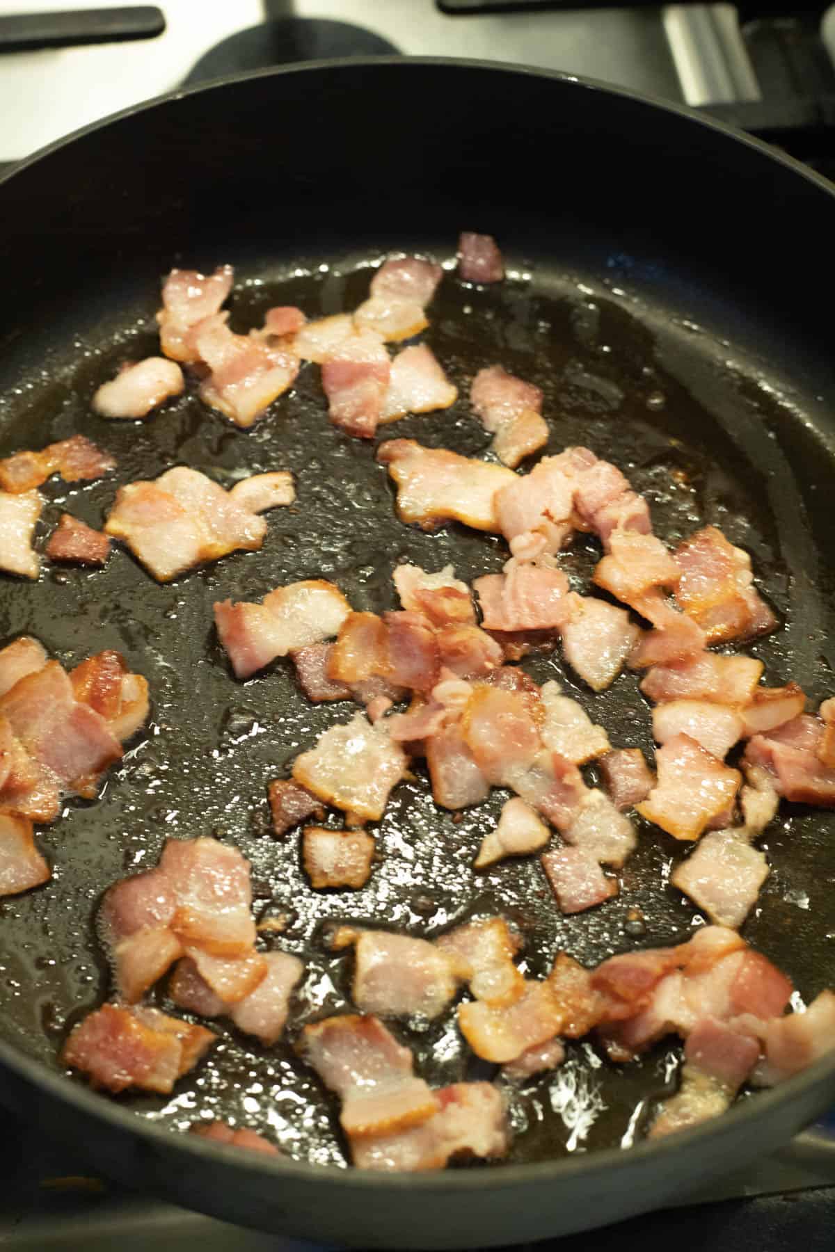 A skillet of cooked bacon.