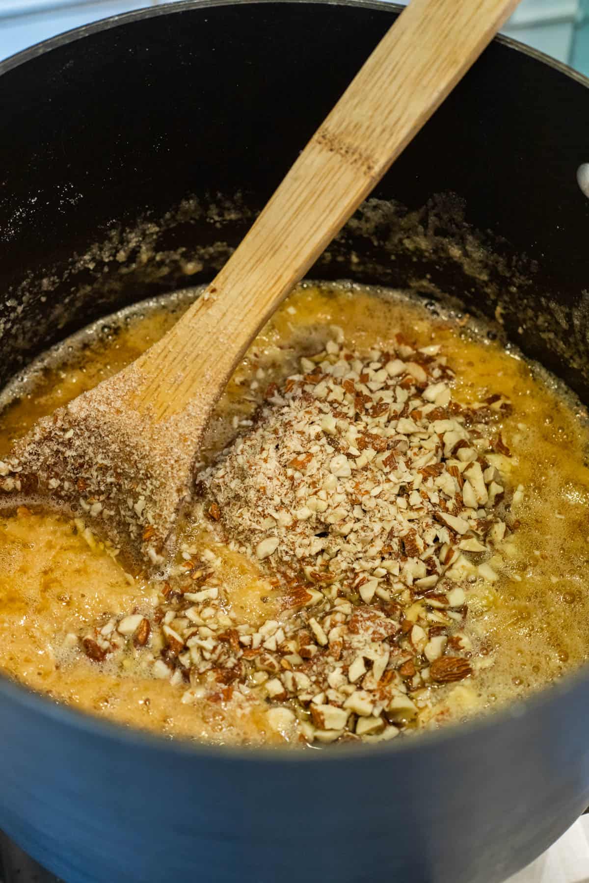 Almonds added to melted butter and sugar mixture.