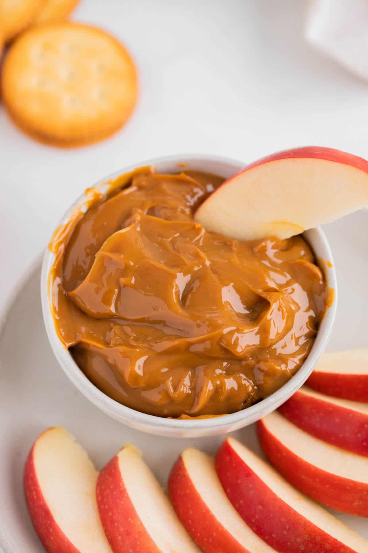A plate of sliced apples with dulce de leche.