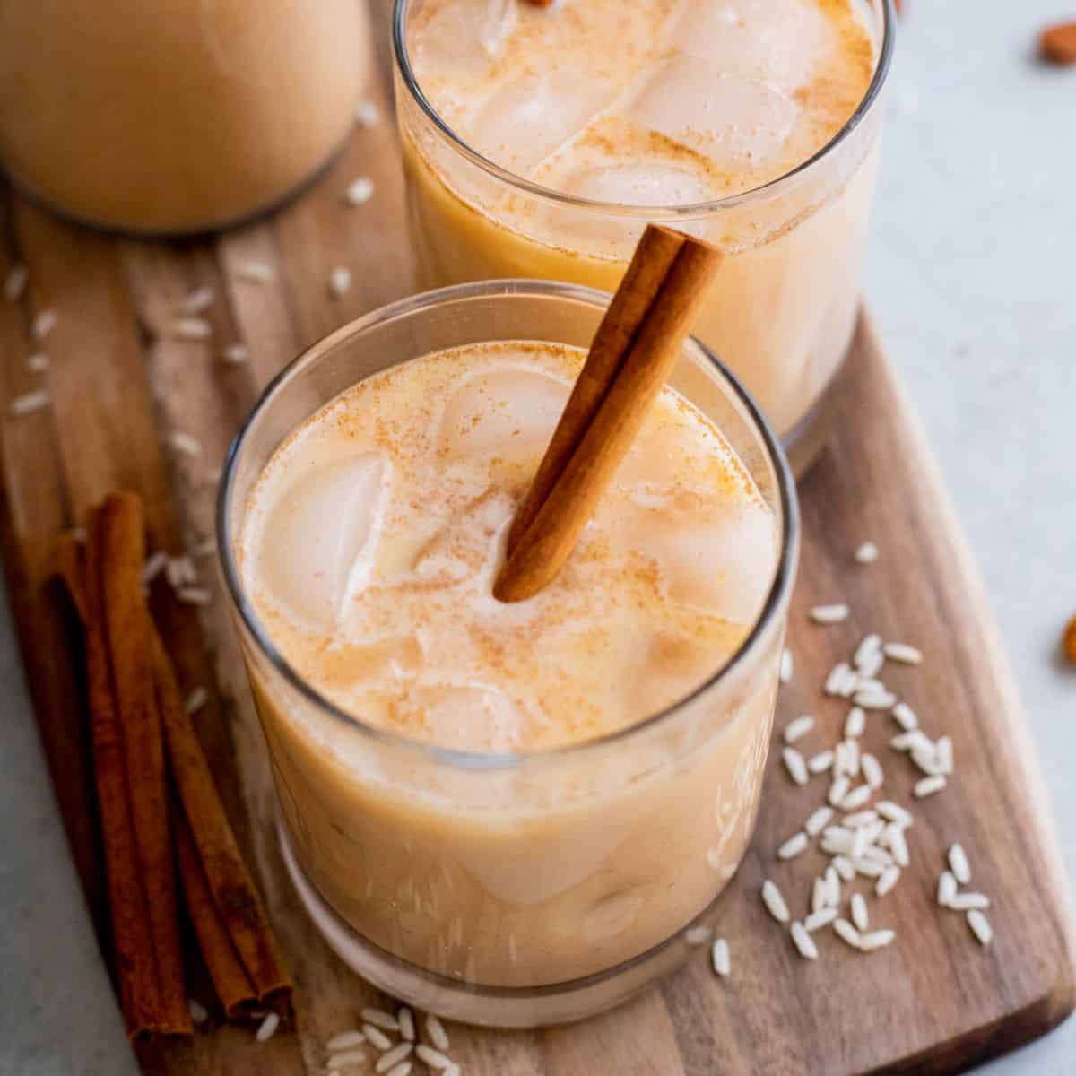Pumpkin horchata in a glass on a wood surface.