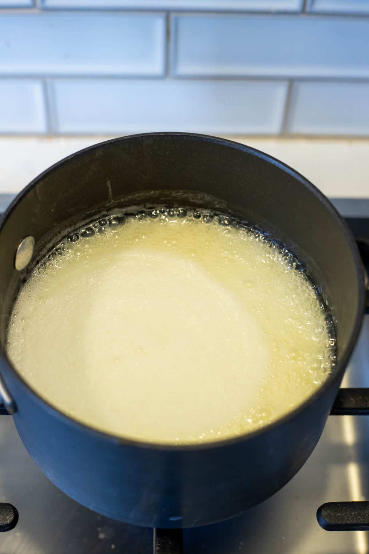 Buttermilk syrup boiling in a saucepan.