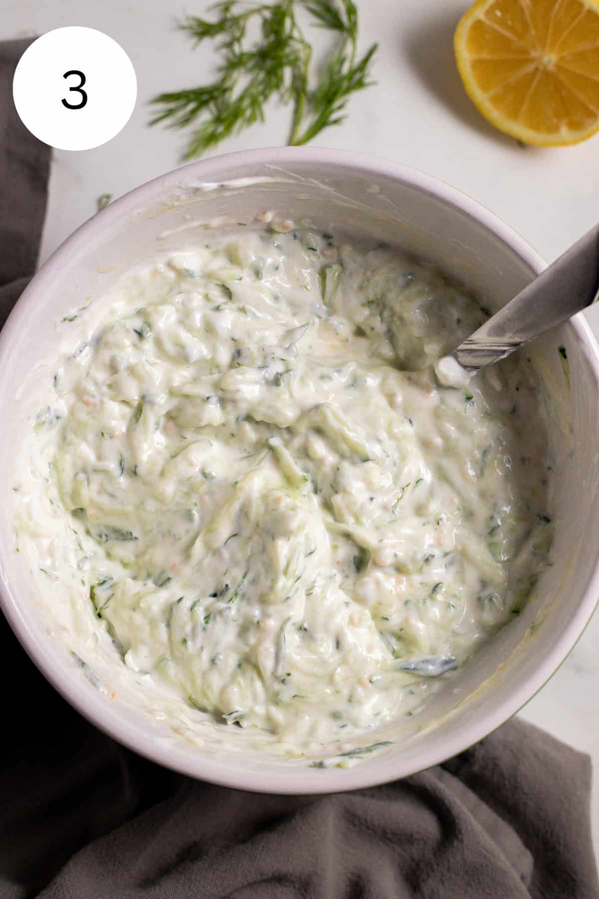 Tzatziki sauce in a white bowl.