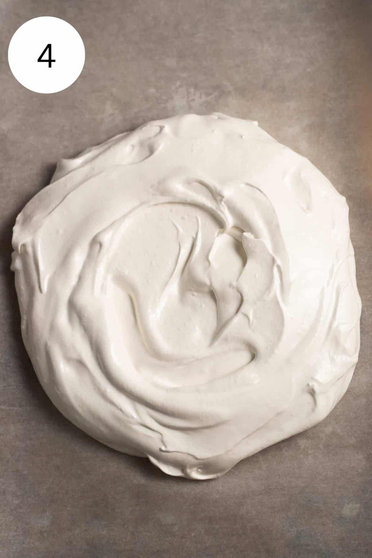 Meringue mixture spread on a baking sheet.