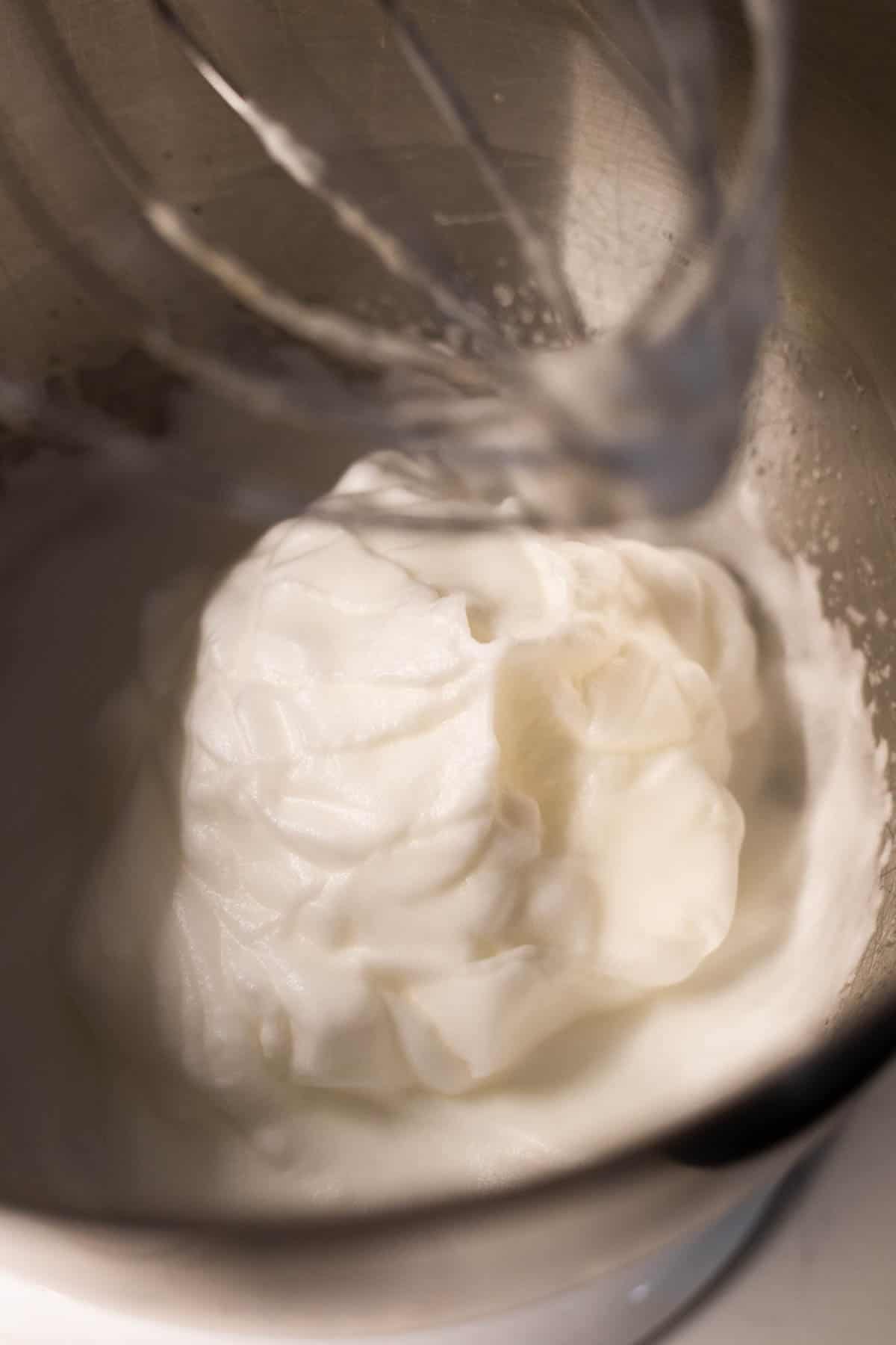 Beaten egg whites in a mixing bowl.