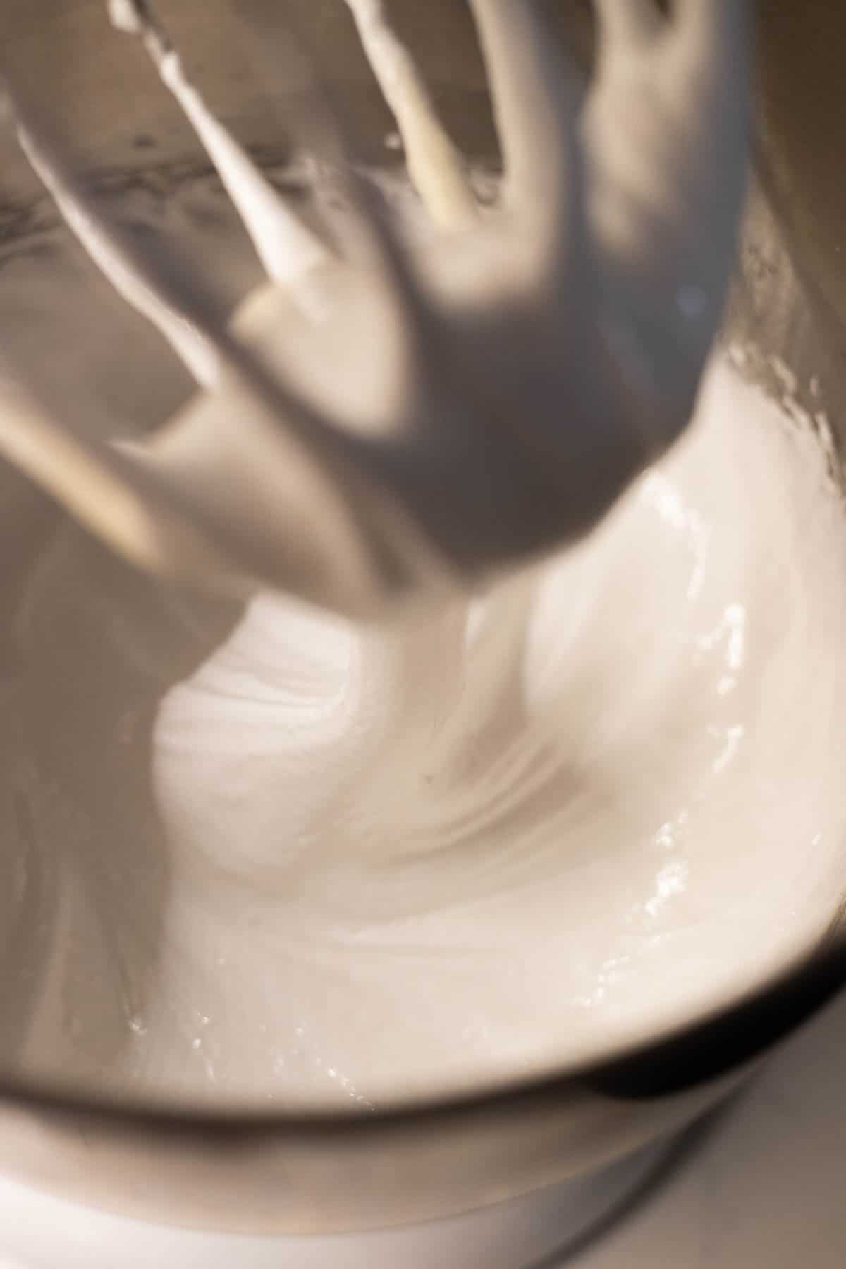 Beaten meringue in a mixing bowl.