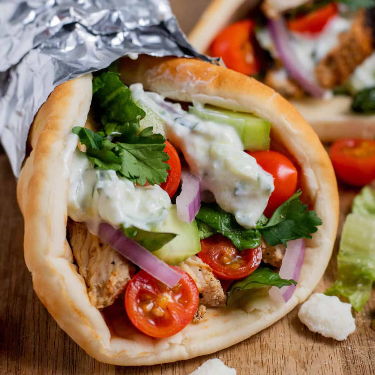 Chicken gyro on a wood surface.