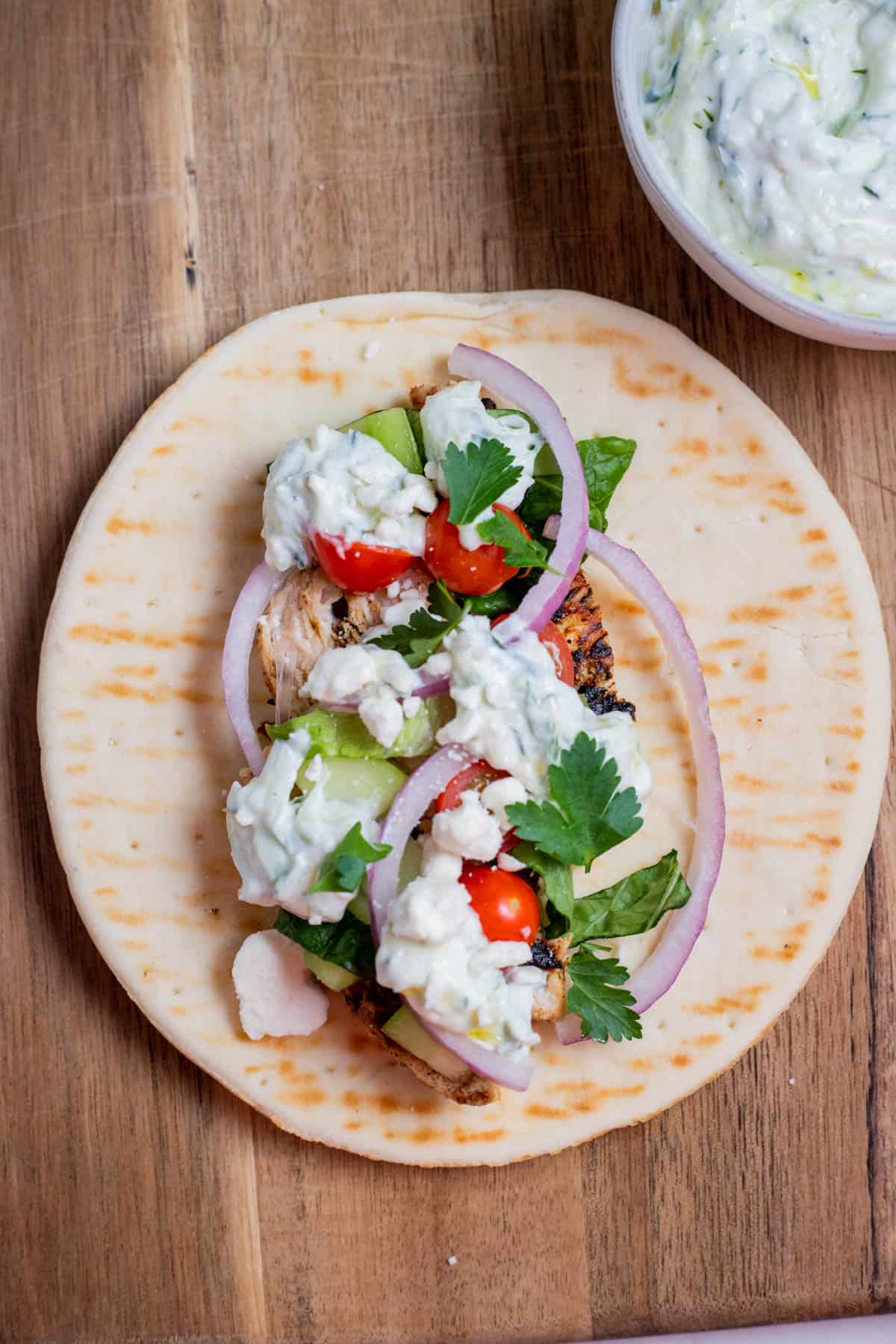 Pita bread with gyro ingredients on top.