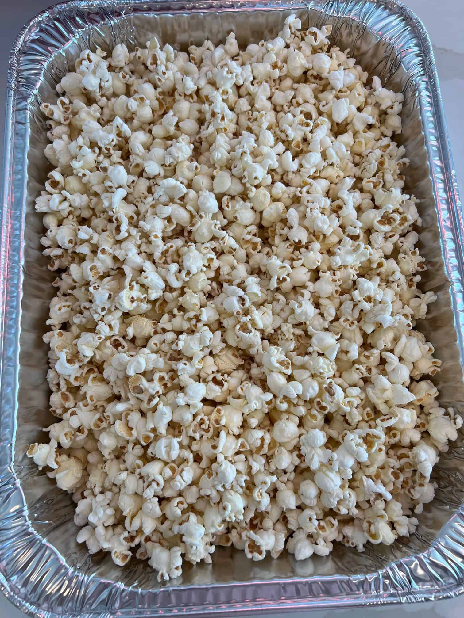 A roasting pan with popped popcorn.