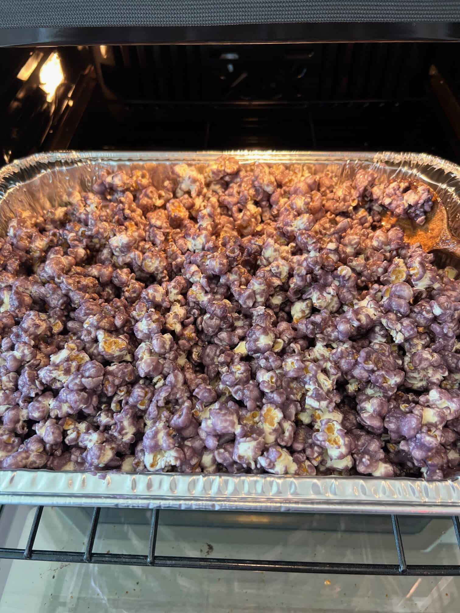 Grape popcorn in the oven in a roasting pan.