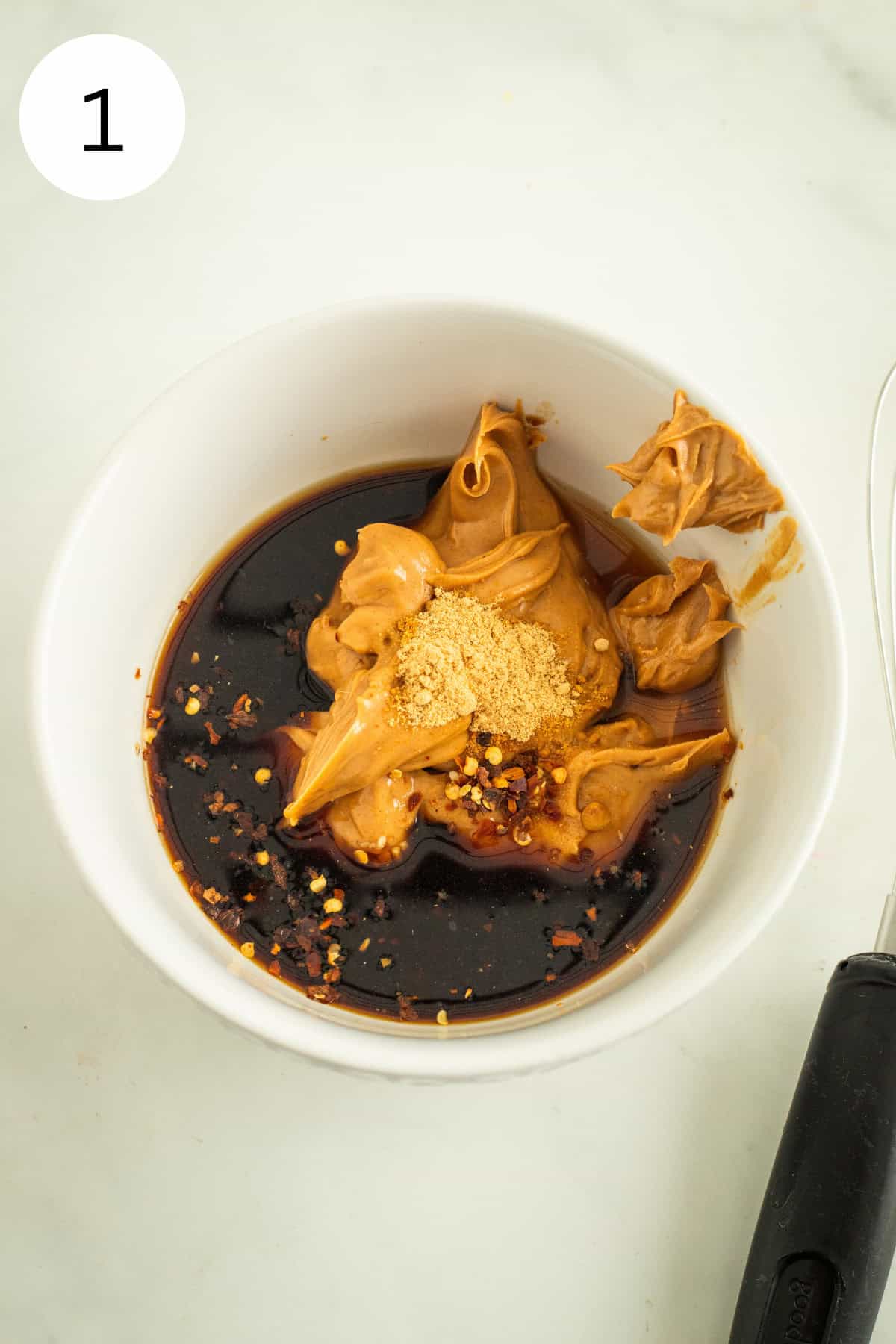 Ingredients for peanut sauce in a white bowl.