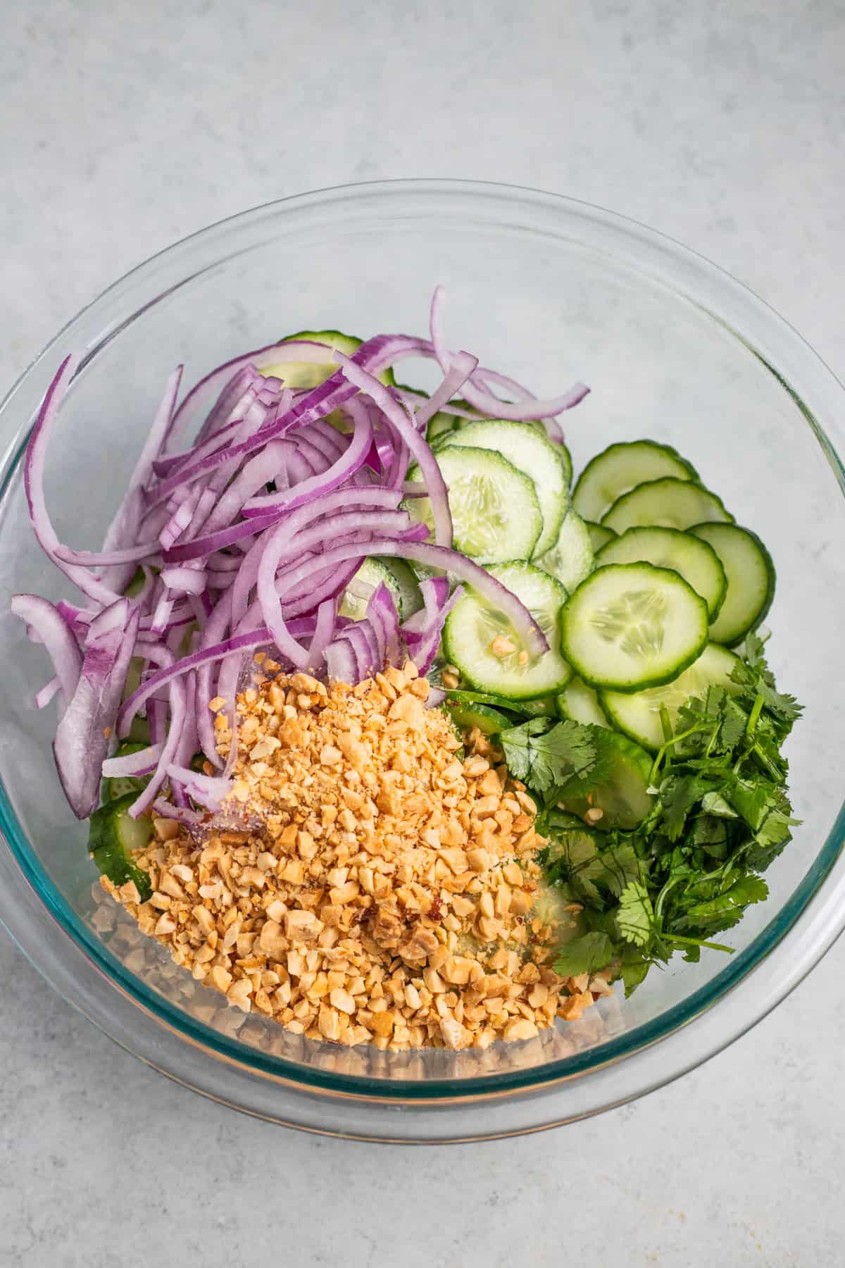 Ingredients for thai cucumber salad in a mixing bowl.