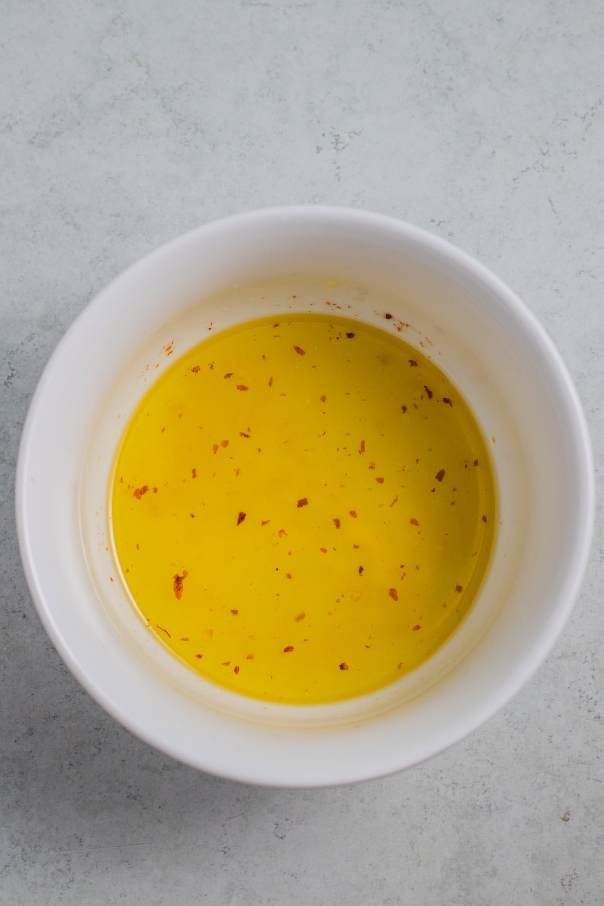 dressing ingredients in a white mixing bowl.