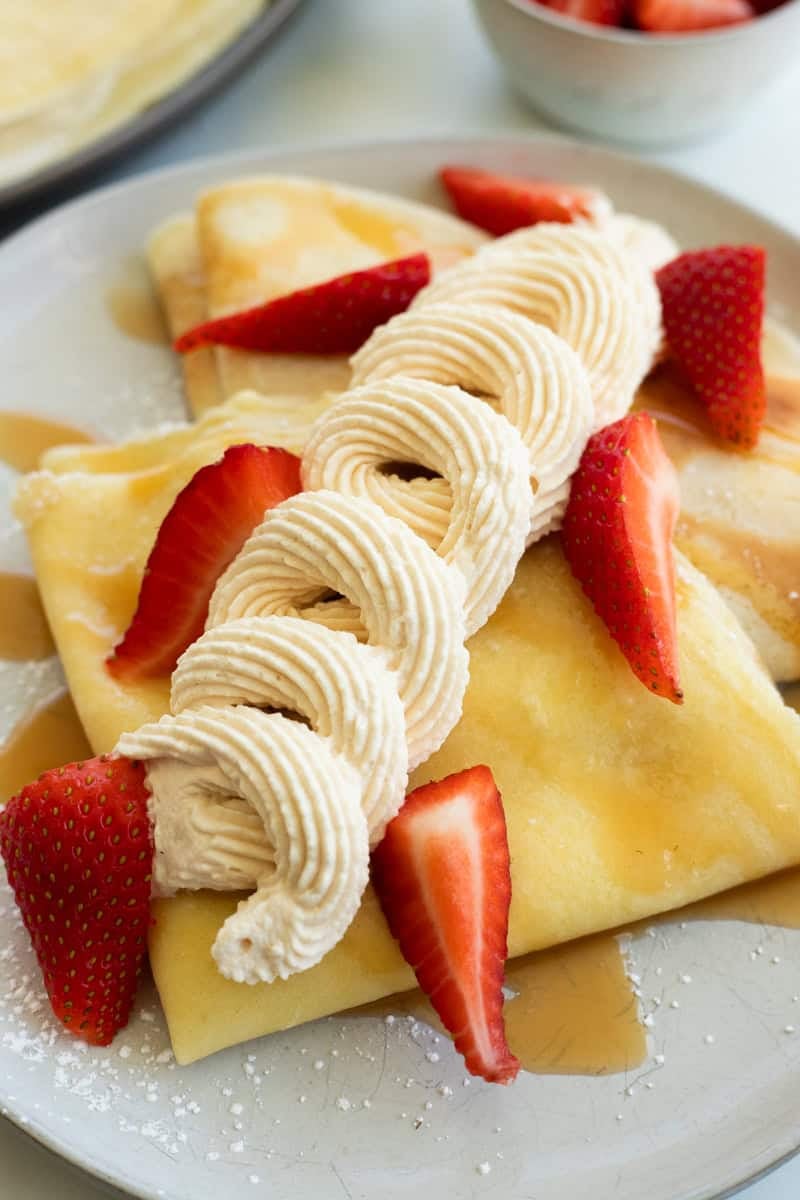 Butterbeer crepes topped with whipped cream and strawberries.