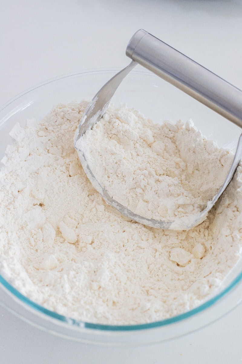 Cutting butter into dry ingredients.