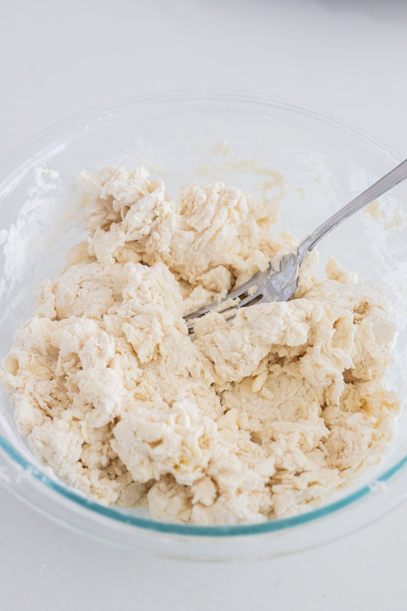 Fork mixing biscuit dough.