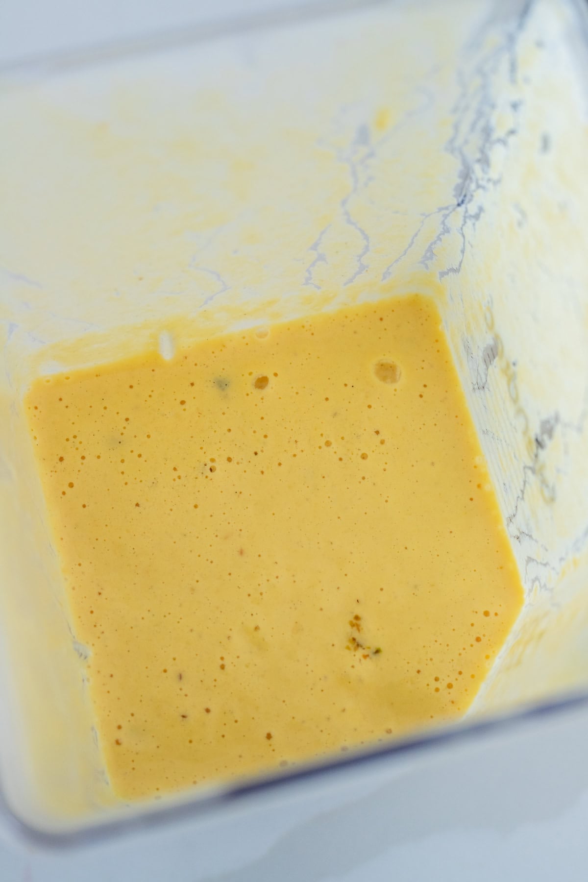 Ingredients in blender blended for peach lassi.