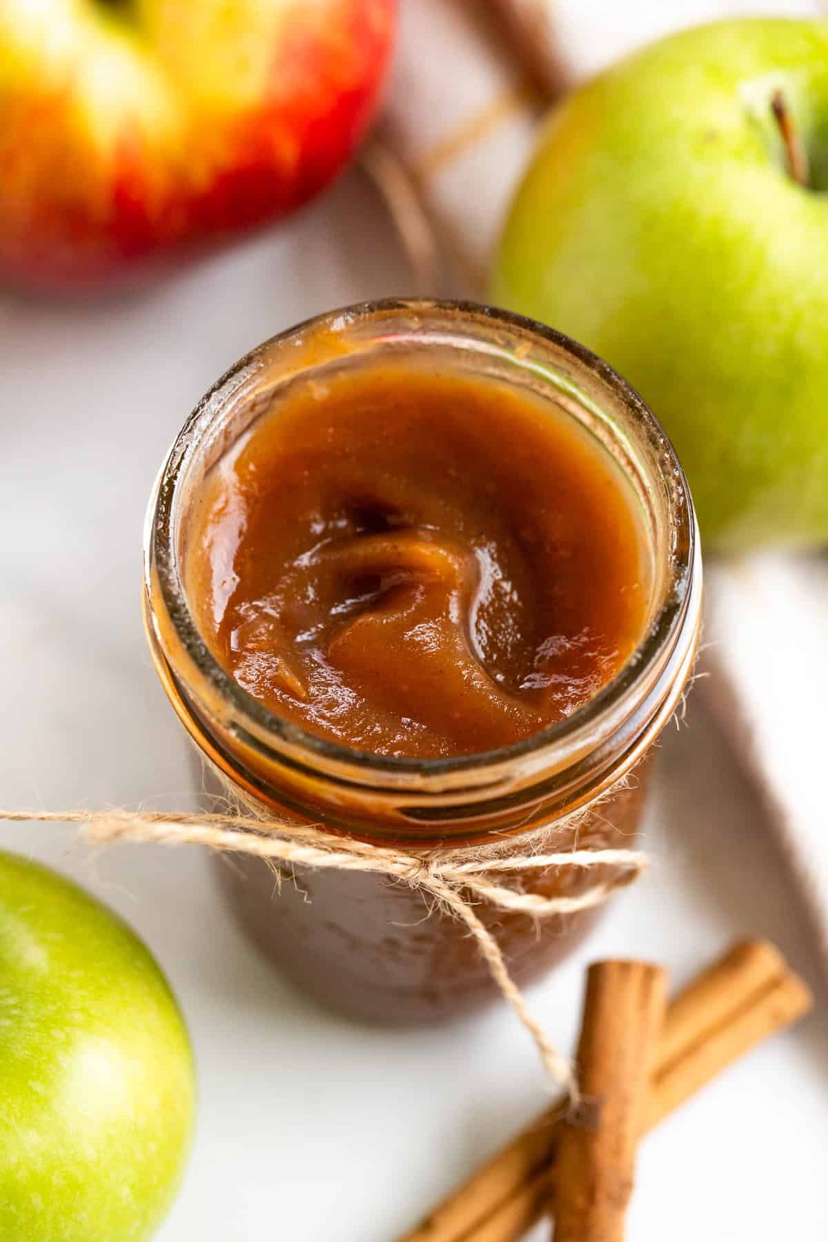 An open glass jar showing apple butter.