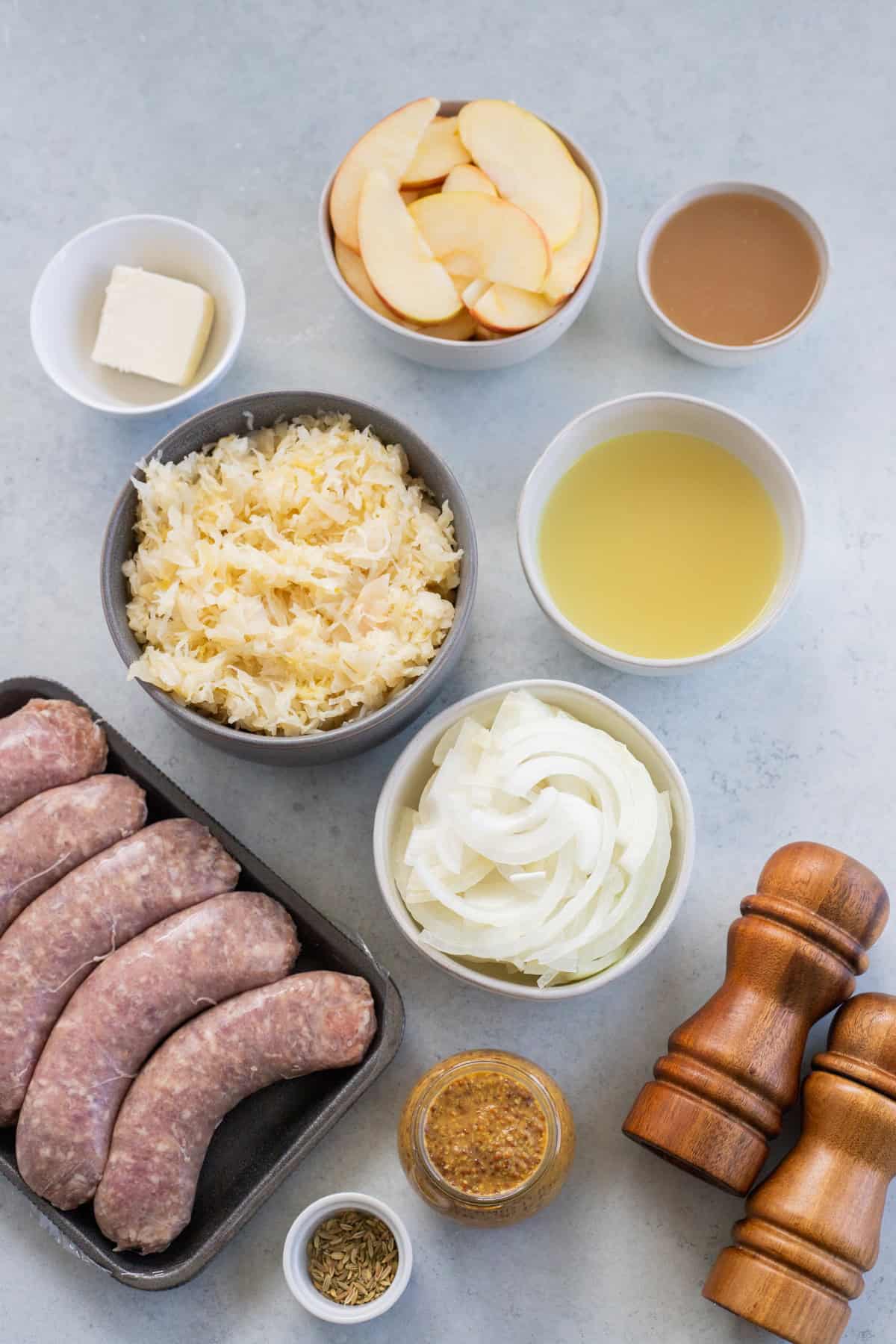 Ingredients laid out for bratwurst and sauerkraut.