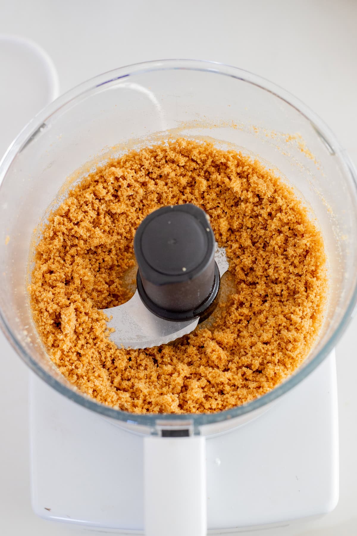 Graham cracker crust ingredients in food processor.