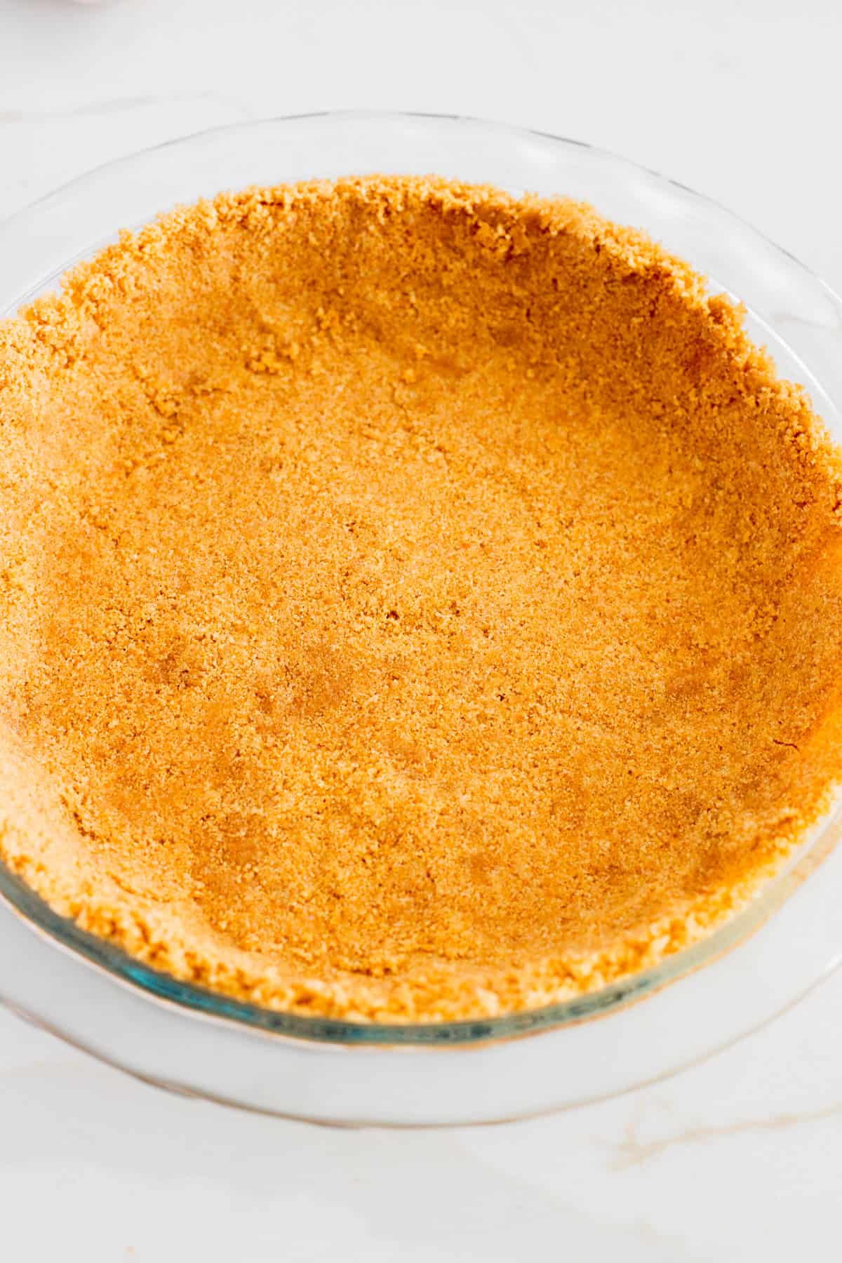 Baked pie crust in glass pie pan.