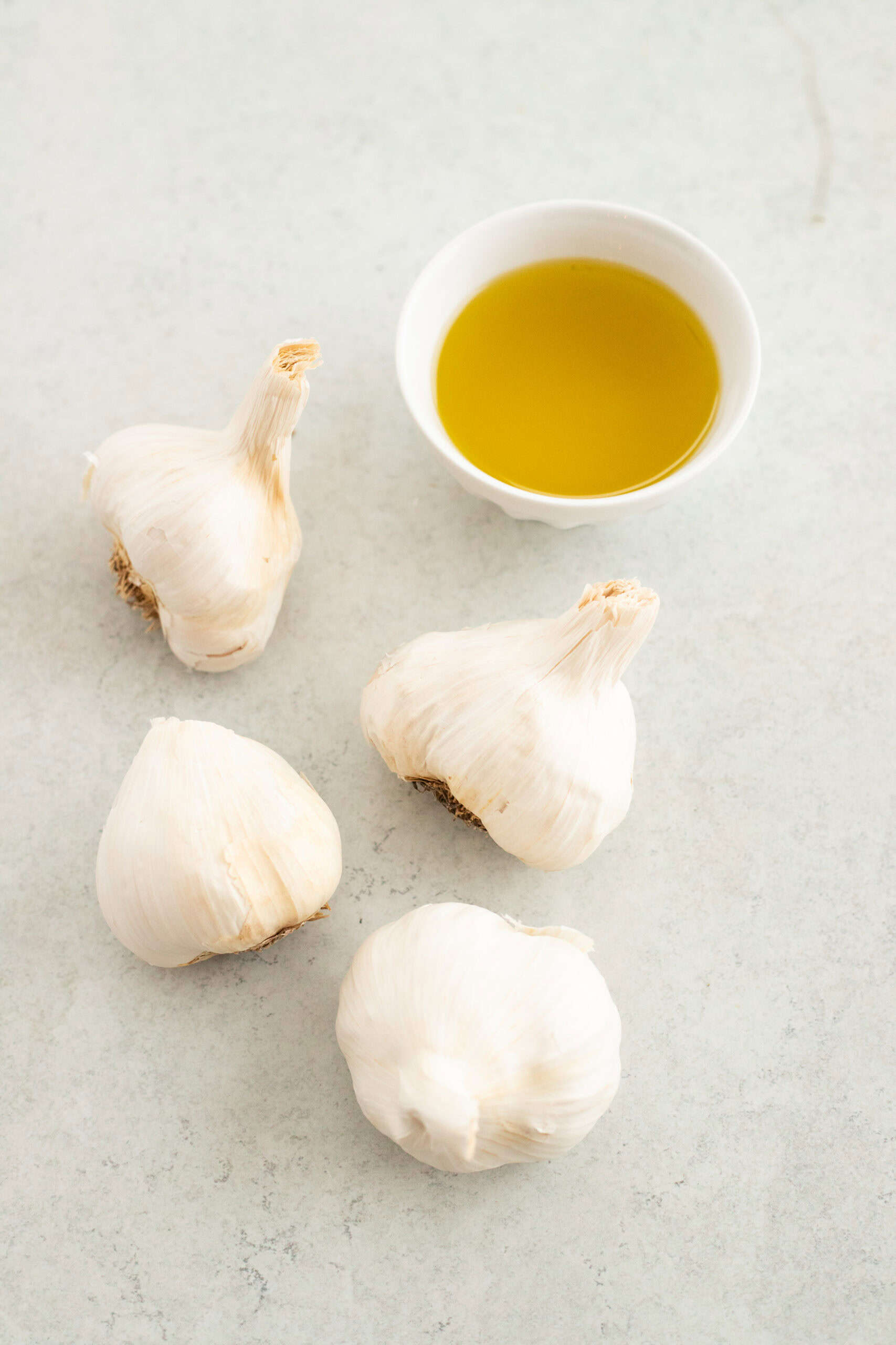 Ingredients laid out for roasted garlic recipe.