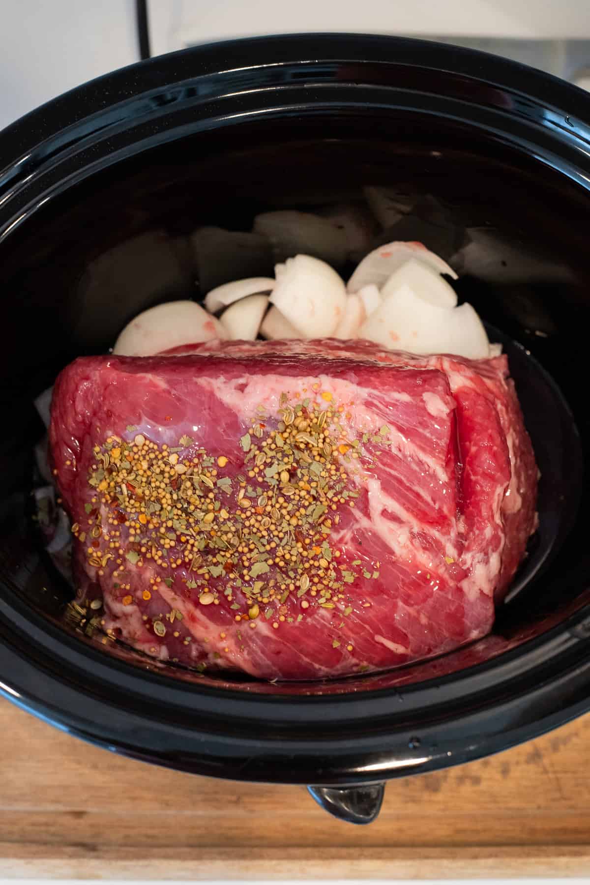 Corned beef and onions in a crockpot.