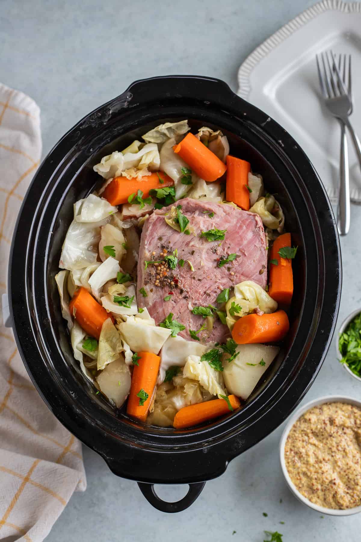 Cooked corned beef and veggies in crockpot.
