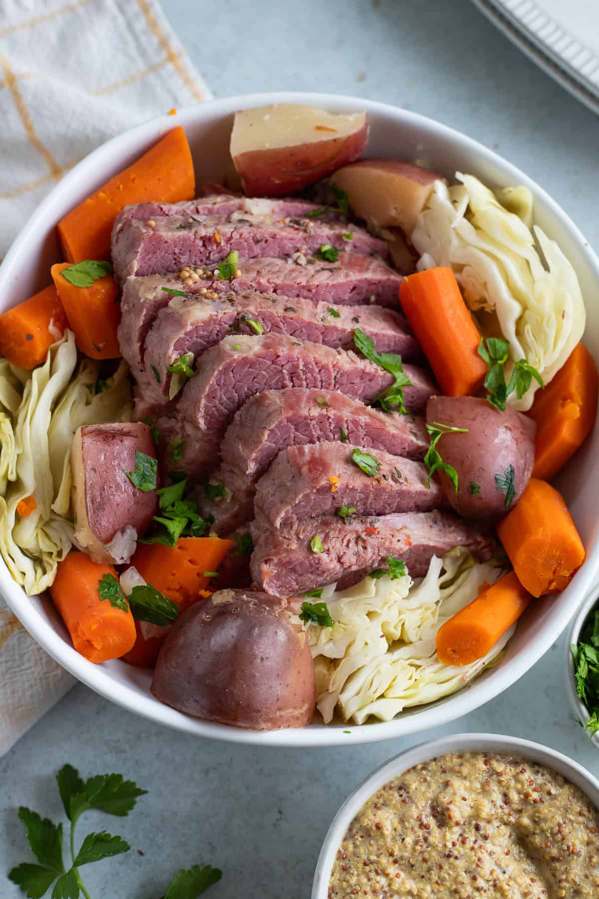 A serving plate with corned beef and veggies.